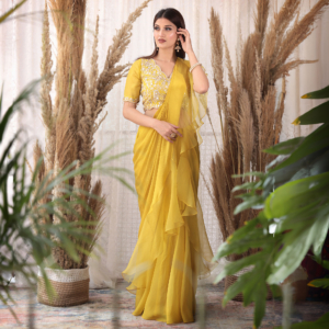 Crepe blouse with a draped skirt in organza and an attached chiffon dupatta with organza ruffles.